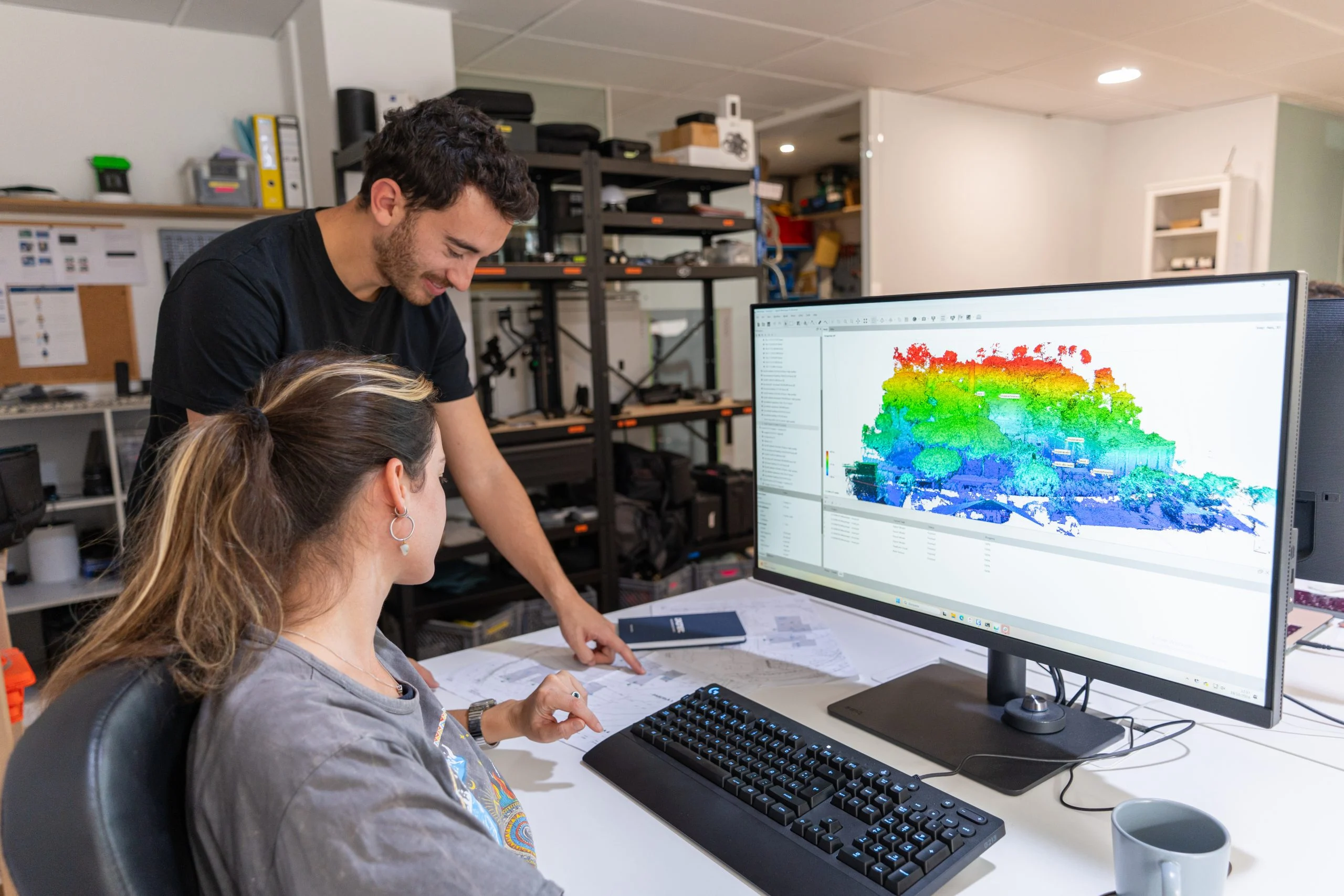 Droneit technicians analysing a point cloud on a computer